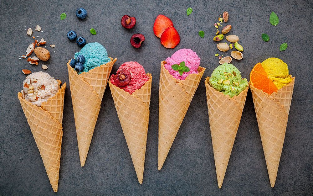 A variety of ice cream cones on a black background