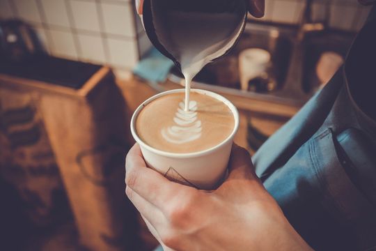 Barista pouring a lattee